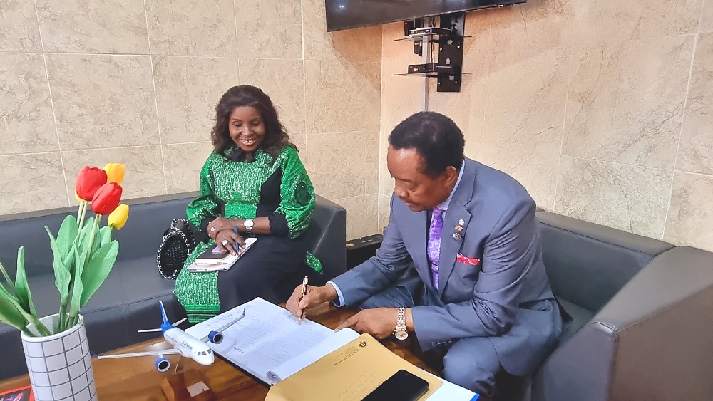 Asiwaju (Dr.) Michael Michael Olawale-Cole, CON and the Director General, Dr. Chinyere Almona, signing the register.