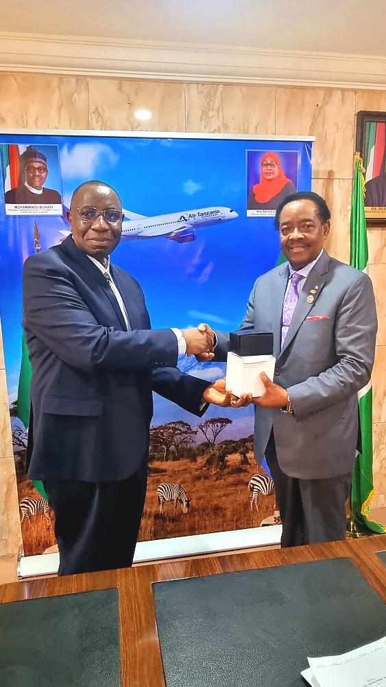 H. E. Dr. Benson Alfred Bana presenting gifts to  Asiwaju (Dr.)  Michael Olawale-Cole, CON.