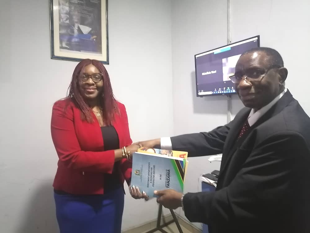 H. E. Dr. Benson A. Bana presenting Tanzania Investment, Trade and Tourism opportunity brochures to Mrs Memberr Tariboba, Member of the Board of Trustee of NANTA Eastern Zone.